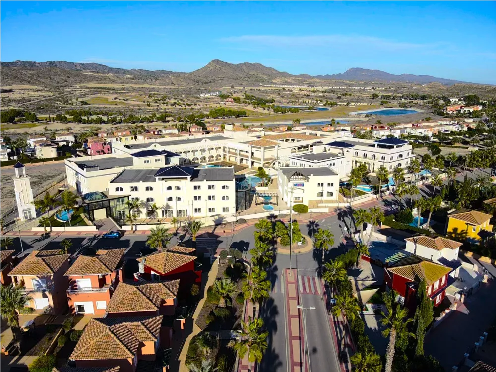 main entrance to Altaona Resort in Murcia with residential area and modern shopping center